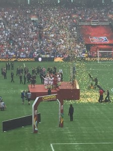 The USWNT celebrating on stage after the game
